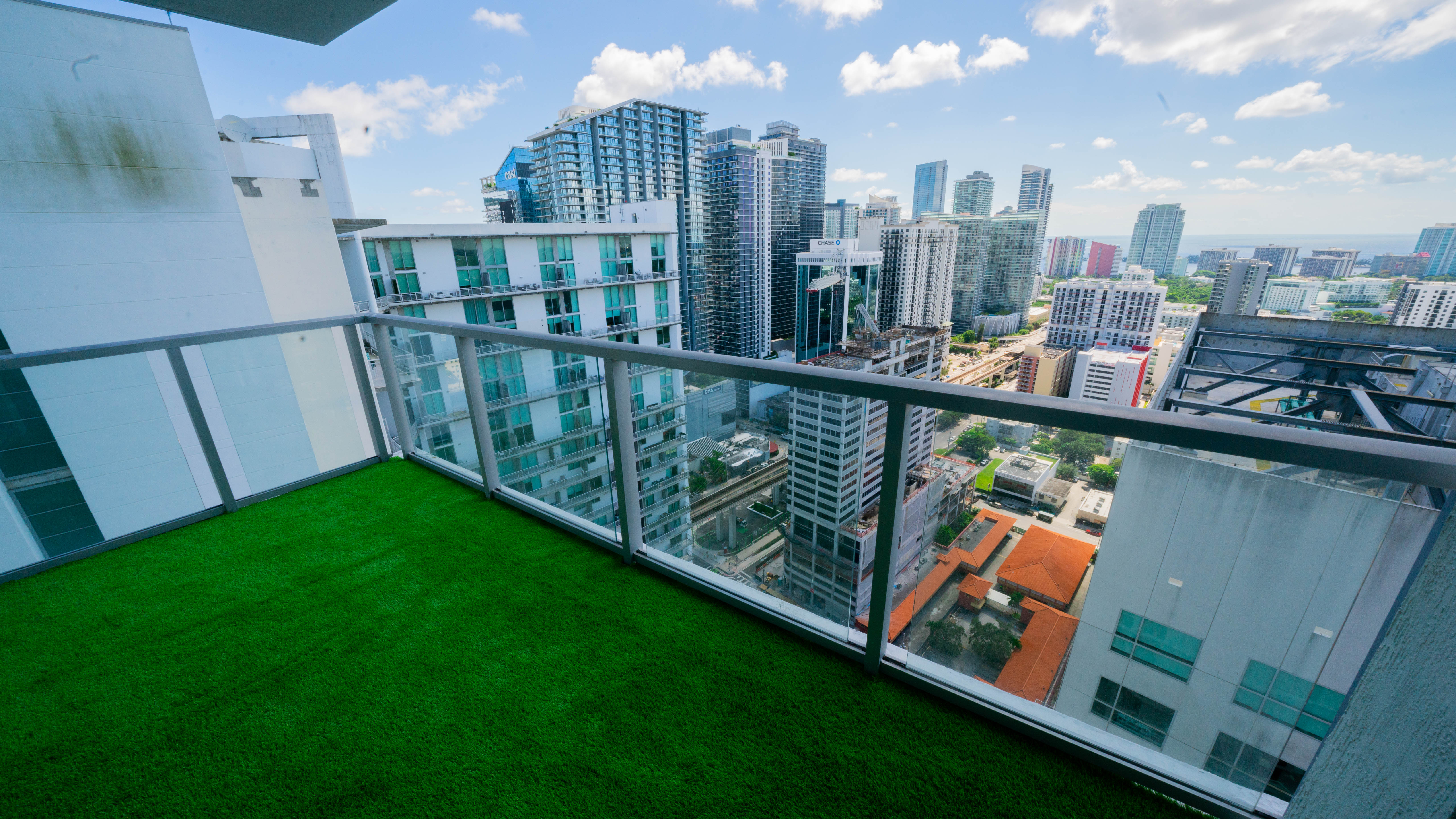 Brickell condo balcony after — green turf installed with clean edges