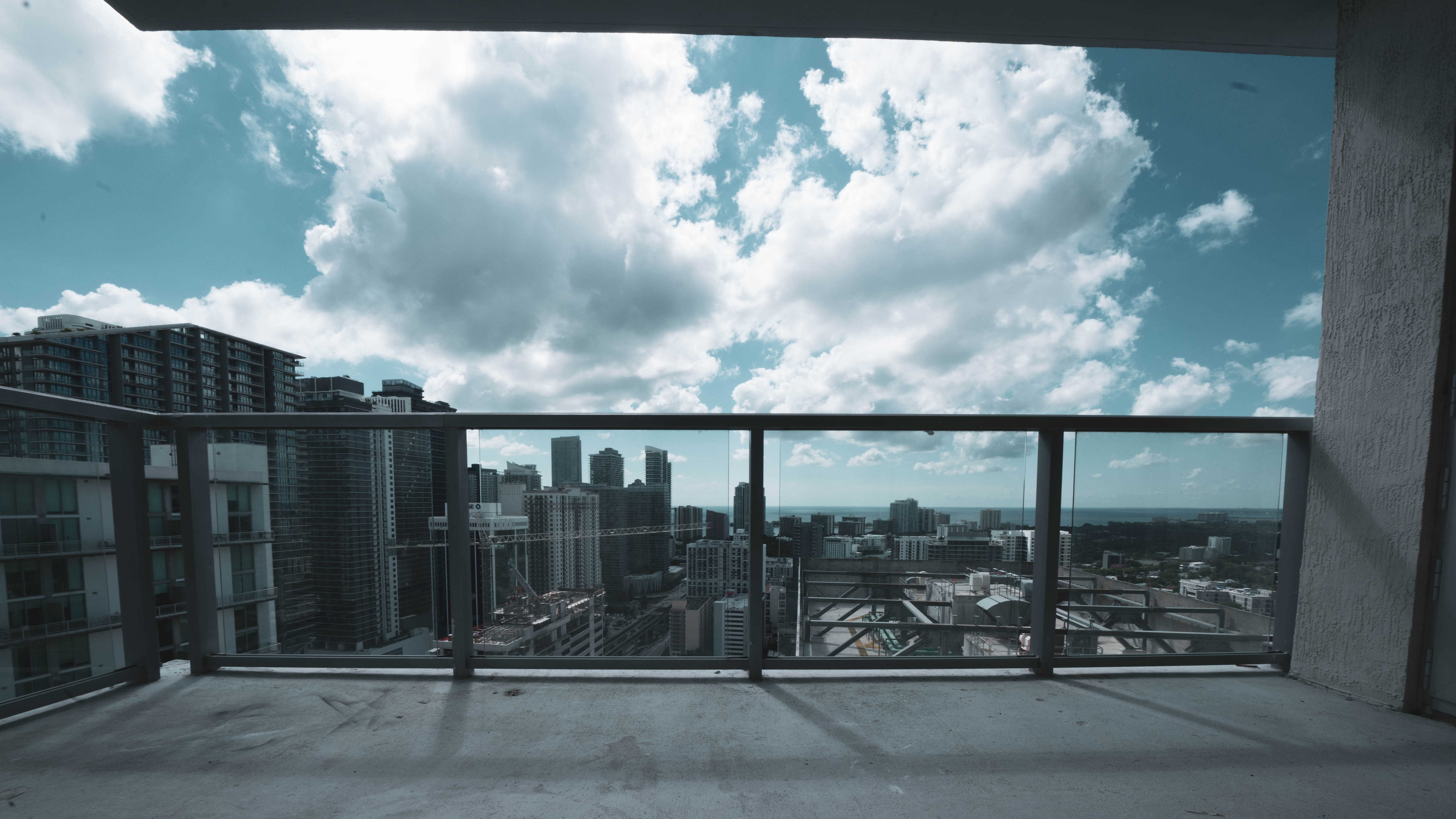 Brickell condo balcony before — another bare concrete slab