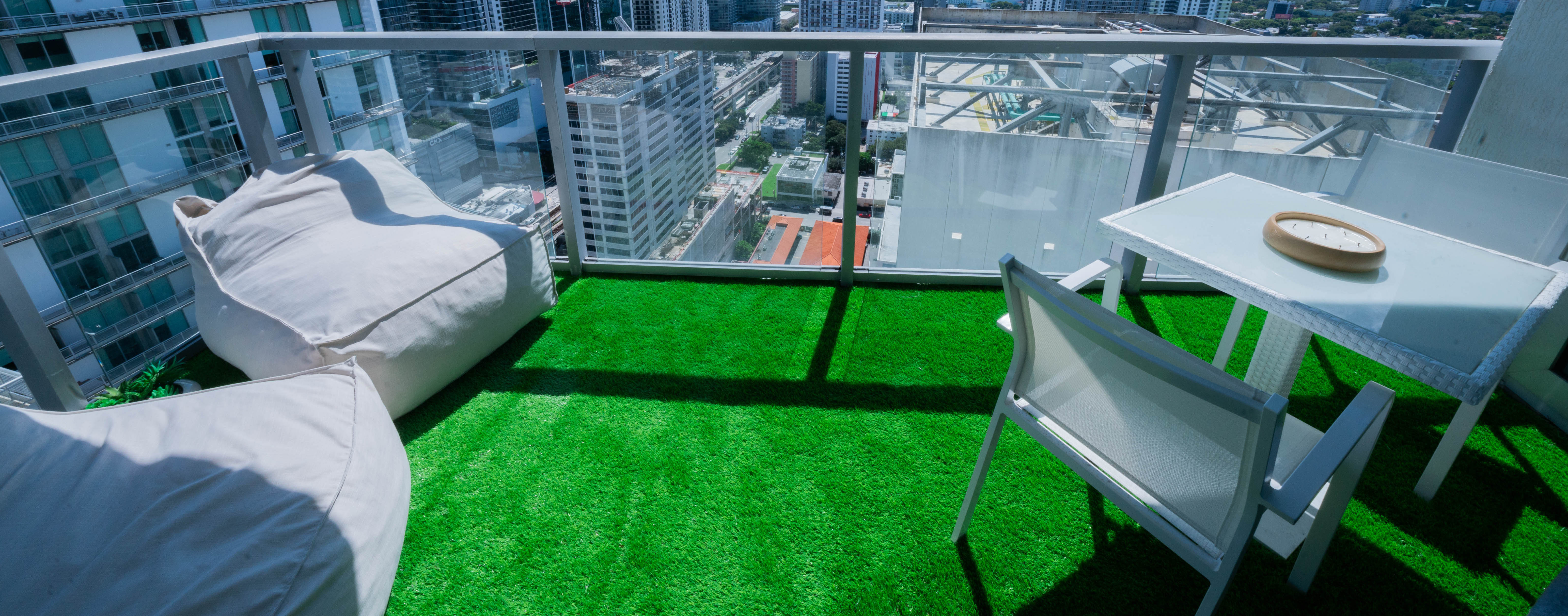 Condo balcony after turf installation — clean, green, removable surface
