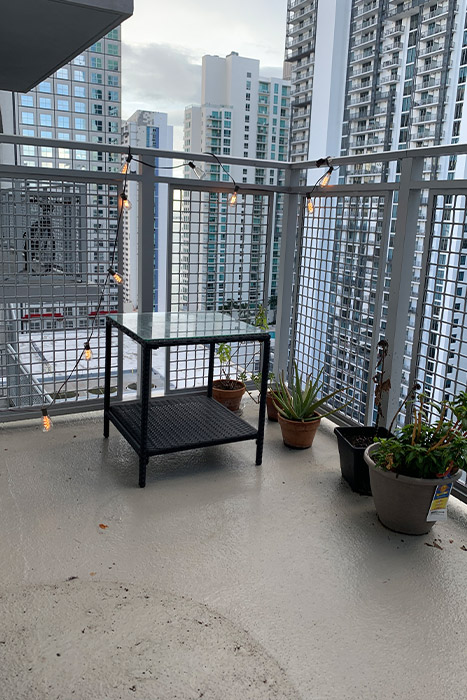 Miami Beach condo balcony with turf — lifestyle shot with outdoor furniture